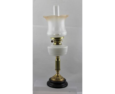 A 20TH CENTURY OIL LAMP with brass column, double burner and opaque shade 