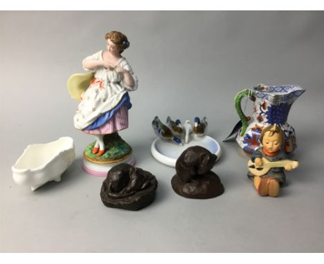 TWO HUMMEL FIGURES OF CHILDREN, along with a Continental painted figure of a female, a Metzler German pin dish with geese in 