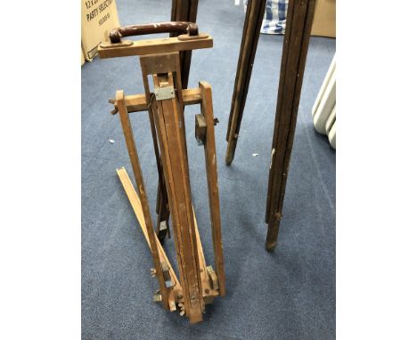 TWO WOODEN EASELS, along with various tools including a saw