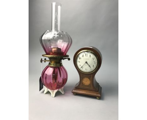 BRASS AND CRANBERRY GLASS OIL LAMP, along with a mahogany inlaid mantel clock