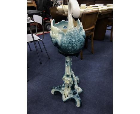 SWAN MOTIF CERAMIC JARDINIERE, decorated in blue, on an ornate stand