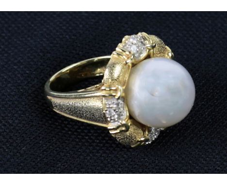 An unusual 18ct gold Ring (size M, approx. 16.6 gms) set with 12 diamonds (.18ct t.c.w.), and set with a cultured South Sea p