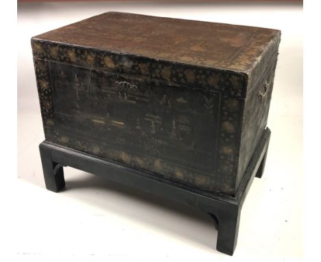 A 19th Century lacquered Chinese Trunk on Stand, decorated in the typical taste with buildings and figures etc., highlighted 