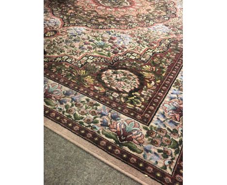 An attractive Middle Eastern style woolen Carpet, with shaped purple ground floral centre and similar shaped surround with st