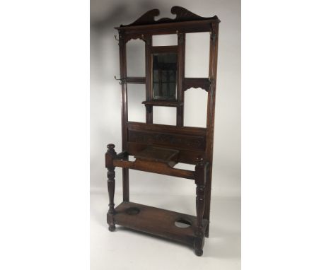 An Edwardian oak Stick and Umbrella Hall Stand, with mirror back and brass hooks. (1)