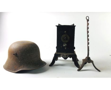 An unusual 19th Century metal Stand, with elaborate interior clock work mechanism, on four out-splayed decorated feet; and a 