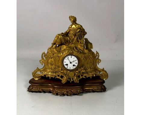 An attractive 19th Century French ormolu Mantle Clock, with a reclining Lady holding a lyre in hand, surmounted on naturalist