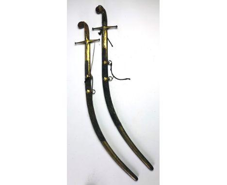 An early 19th Century Indian Sabre, in an engraved brass and animal skin scabbard, signed with stamp, but damaged (seized up 