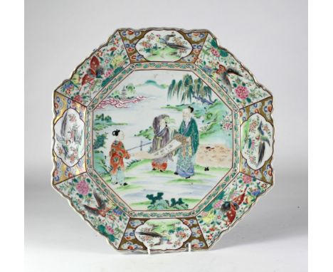 A large 19th Century Chinese Famille Verte octagonal Platter, the central panel with three figures holding a script scroll su