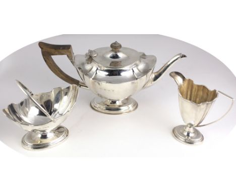 An attractive three piece silver Tea Service, Birmingham 1915, comprising an oval vase shaped lobed teapot on stem base, a ma