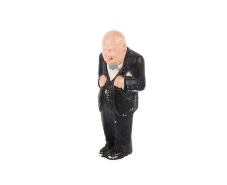 A vintage painted plaster model of Winston Churchill. Standing in a black suit and blue bow tie, glancing to the left, his ha