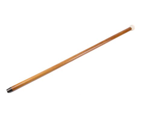 An early 20th century gadget walking cane. The ivory knob unscrewing to reveal a wood and brass mounted knife and fork set, t