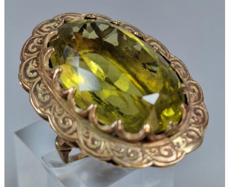 9ct gold green stone dress ring of large oval form. 21.5g approx. Size L1/2. (B.P. 21% + VAT)