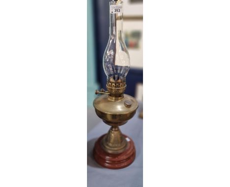 Early 20th century double oil burner lamp, having brass reservoir on brass and ceramic moulded base.   (B.P. 21% + VAT) NO IN