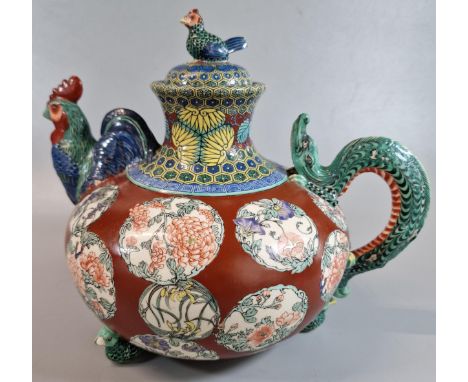 Japanese Satsuma export pottery teapot, overall decorated in polychrome enamels with roundels of flowers on an iron red groun
