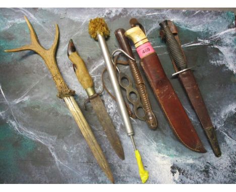Mixed daggers to include one having a taxidermy paw handle, the blade marked A Orosdi, a ''LE COMMANDO'' French Fairbairne &a