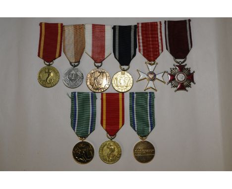 Group of nine Polish military medals including red enamel Cross PRL 