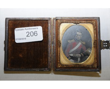 Cased Victorian daguerreotype miniature military portrait on glass in gilt mount and frame depicting seated cavalry figure 