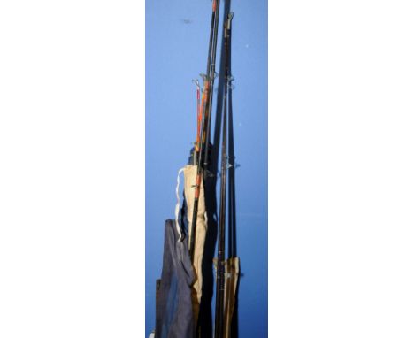 Large selection of sea fishing rods, mostly fibre, including five piece split cane rod and a three sectional vintage wooden r