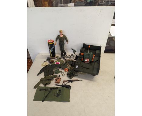 A vintage Action Man together with accessories to include uniform, rifles, mission pad and a large trailerLocation: 
