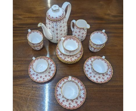 A Spode fine bone china Fleur de Lys Red pattern tea service comprising a coffee pot, cream jug, bowl and eight cups and sauc