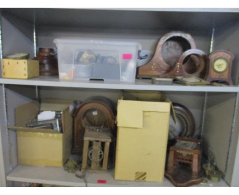 Two shelves of various clock cases and parts, for spares and repairs to include car clocks, mantel clocks and othersLocation: