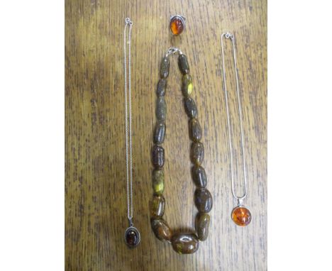 A national raw amber graduated beaded necklace, 49.2g, a 925 silver ring with cabochon amber pendant on 925 silver chain neck