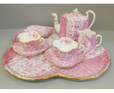 A Wileman &amp; Co. Cabaret pattern late 19th Century part tea set, comprising teapot, milk jug, two cups, four saucers and t