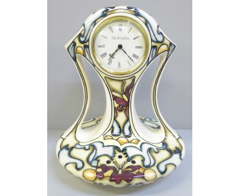 A Moorcroft limited edition Black Ryden clock, Time Flight pattern, 65/100, signed K. Goodman, 25cm 