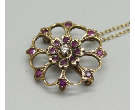 A yellow metal, ruby and diamond pendant/brooch on a 9ct gold chain, pendant stamped 9K, 5g, 2.6cm pendant 