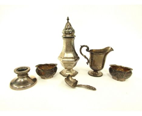 A silver sugar castor, a Georgian caddy spoon, silver squat form candlestick, cream jug and a pair of silver salts (6) 