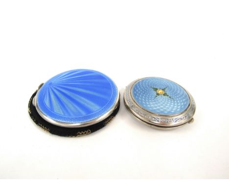 A W I Broadway and Co silver mirror compact with blue guilloche sunburst design, Birmingham 1940 with a similar powder compac