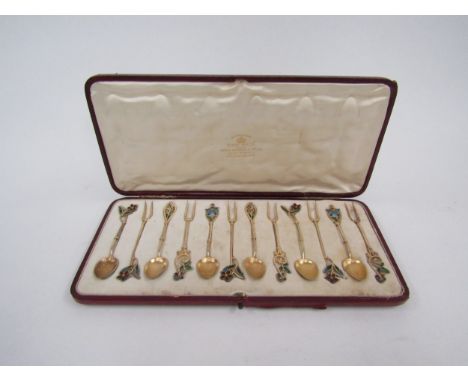 A set of six floral plique a jour enamel silver gilt spoons and forks, Birmingham 1897, in fitted case