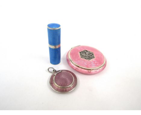 A mirrored powder compact stamped 925, all over pink guilloche with a marcasite flaming torch motif to centre, a mauve guillo