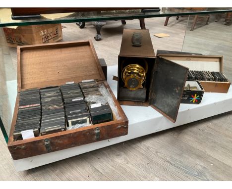 A Magic lantern and a collection of vintage glass Magic Lantern slides, themes include British Army, History of Flight, Londo