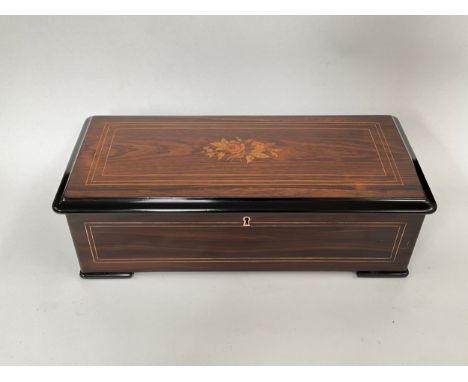 A 19th Century Nicole Freres cylinder music box playing six airs, rosewood and ebonised case, marquetry top, 15cm x 49cm x 22
