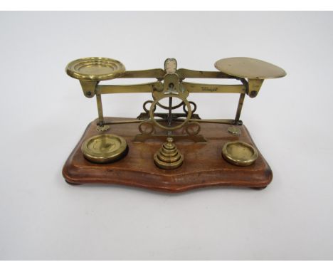 A set of brass postal scales with weight 