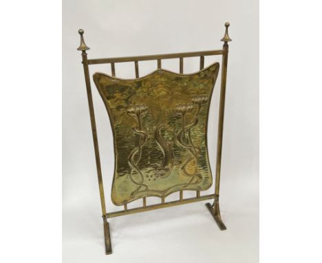 An Edwardian Art Nouveau brass fire screen with fish and floral detail 