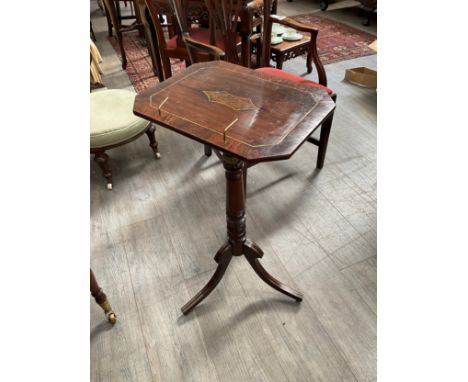 A Regency rosewood music table with tilt and lock mechanism over turned and glazed column to tripod base, 76.5cm x 43cm x 33.