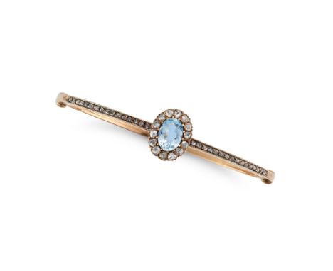 AN ANTIQUE AQUAMARINE AND DIAMOND BANGLE in yellow gold, the hinged bangle set with an oval cut aquamarine of approximately 1