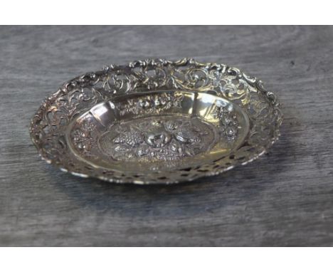 Victorian silver oval trinket dish, repousse fruit decoration to centre with smaller fruit design border surround, the pierce