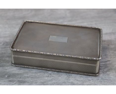 Silver cigarette box, with scalloped lozenge engine turned decoration to lid, base and sides, blank rectangular cartouch and 