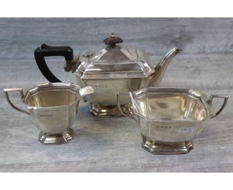 George VI three piece silver tea service comprising teapot, sugar bowl and milk jug, rectangular fluted form raised on steppe