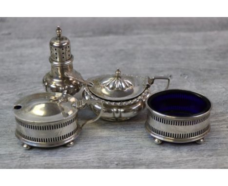 George V silver mustard pot and silver open oval salt cellar and matching mustard pot, raised on four bun feet, pierced recta