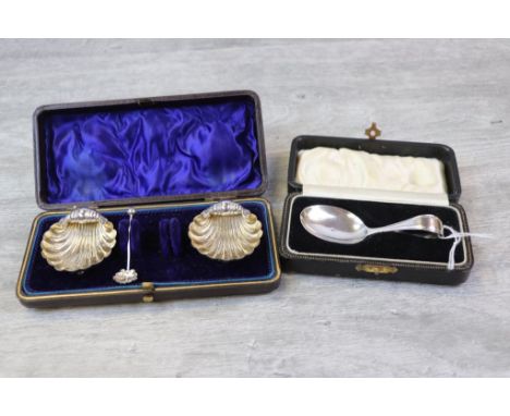 Pair of Victorian silver salts modelled as scallop shells, raised on three ball feet, with single salt spoon (one missing) ma