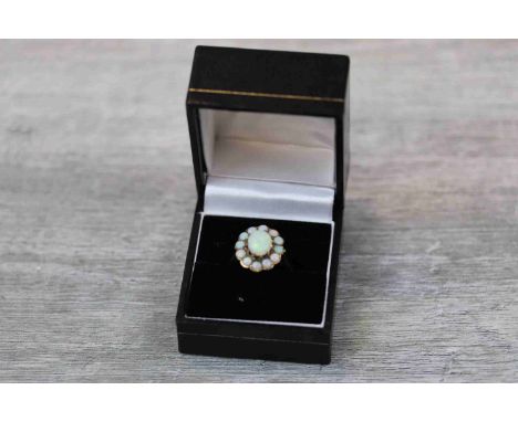 Opal 9ct yellow gold cluster ring, the central oval cabochon cut precious white opal displaying green, yellow and orange play