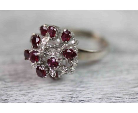 Ruby and diamond 14ct white gold fancy cluster ring comprising twelve oval mixed cut claw set rubies each measuring approxima