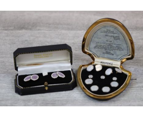 Pair of early twentieth century enamelled silver cufflinks, each oval panel with purple enamelled centre depicting rose desig