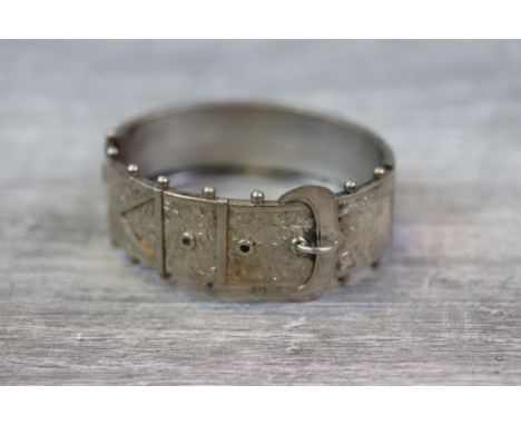 Late 19th century continental silver hinged buckle bangle, the upper half modelled as a buckle with engraved floral decoratio