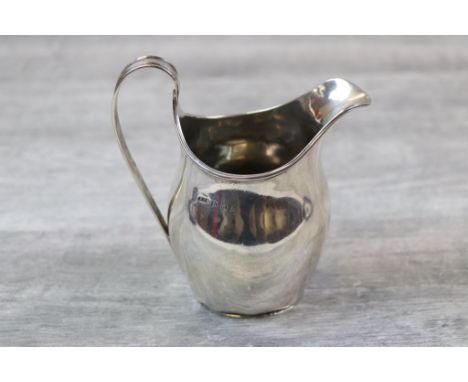 George V silver helmet shaped cream jug of plain form with reeded handle and rim, makers F C Richards, Birmingham 1924, heigh